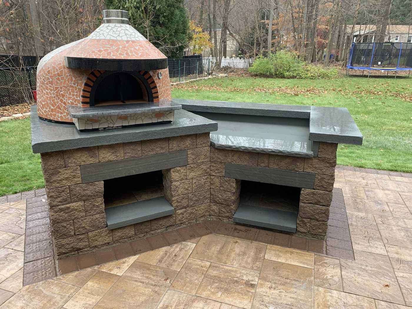 Custom mosaic-tiled outdoor pizza oven on a masonry base with bluestone countertops in Ringwood NJ