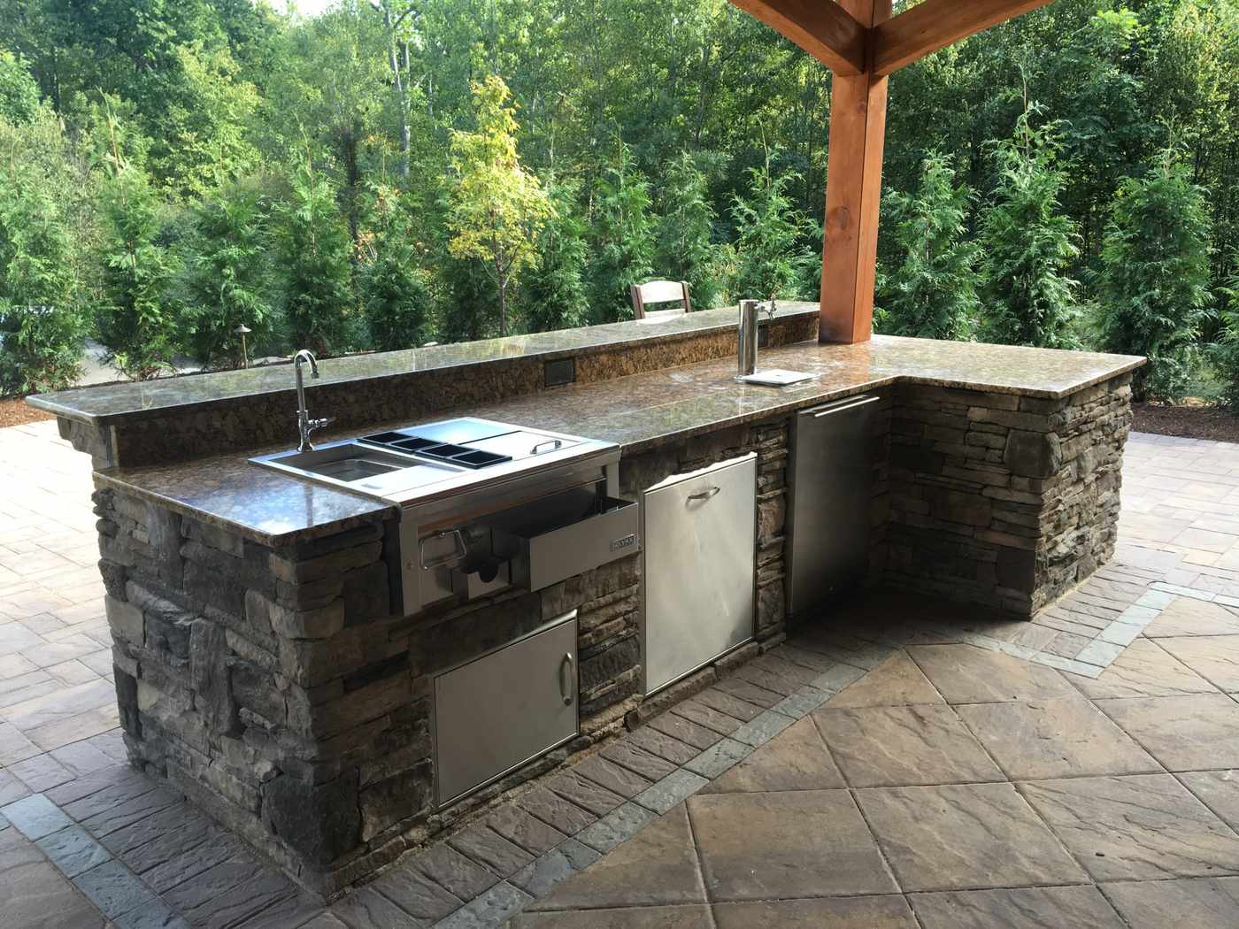 Custom stone veneer outdoor kitchen with granite countertops and stainless appliances in Ringwood NJ
