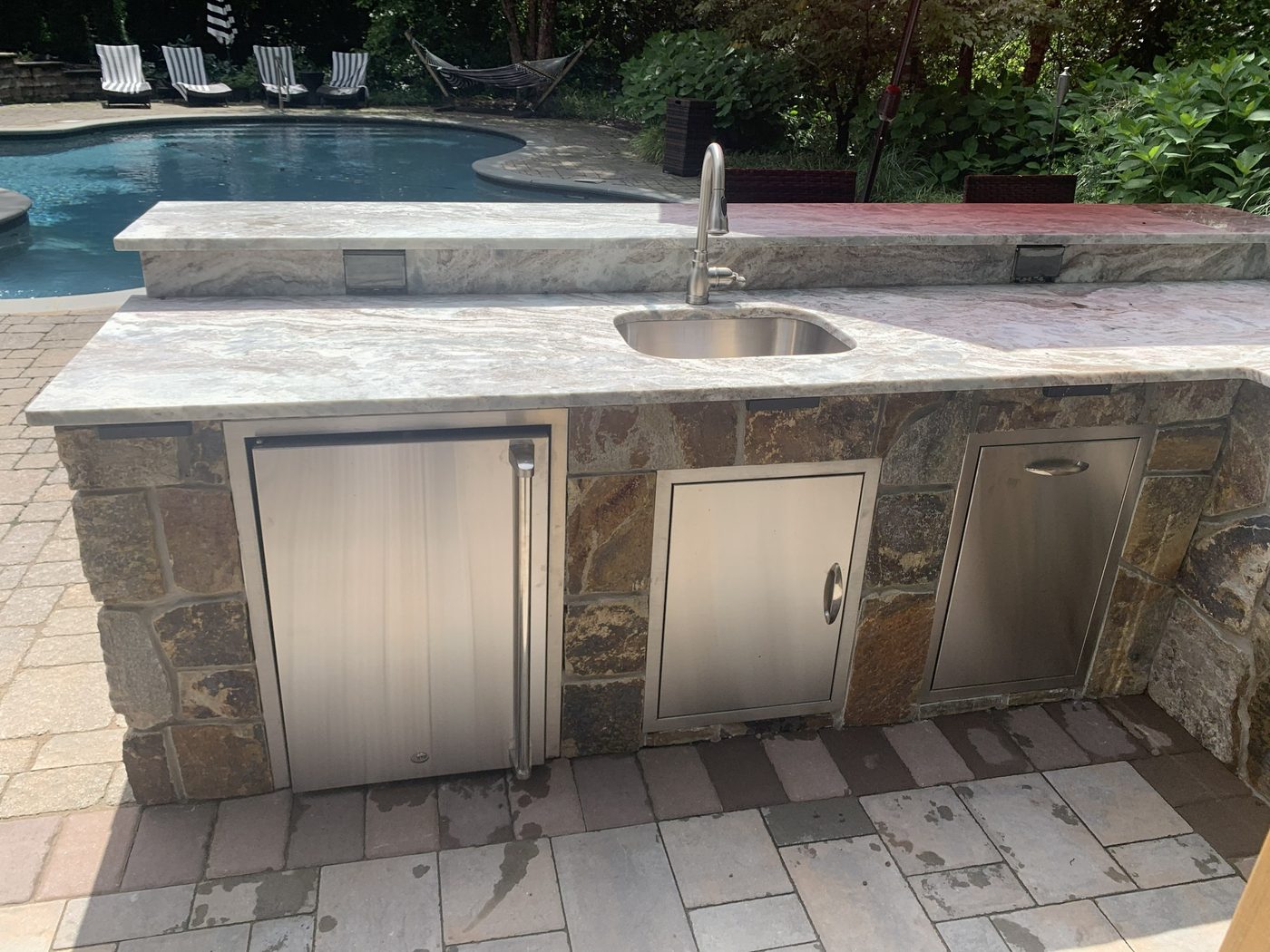 Custom outdoor kitchen and backyard entertaining feature installation in Ringwood NJ