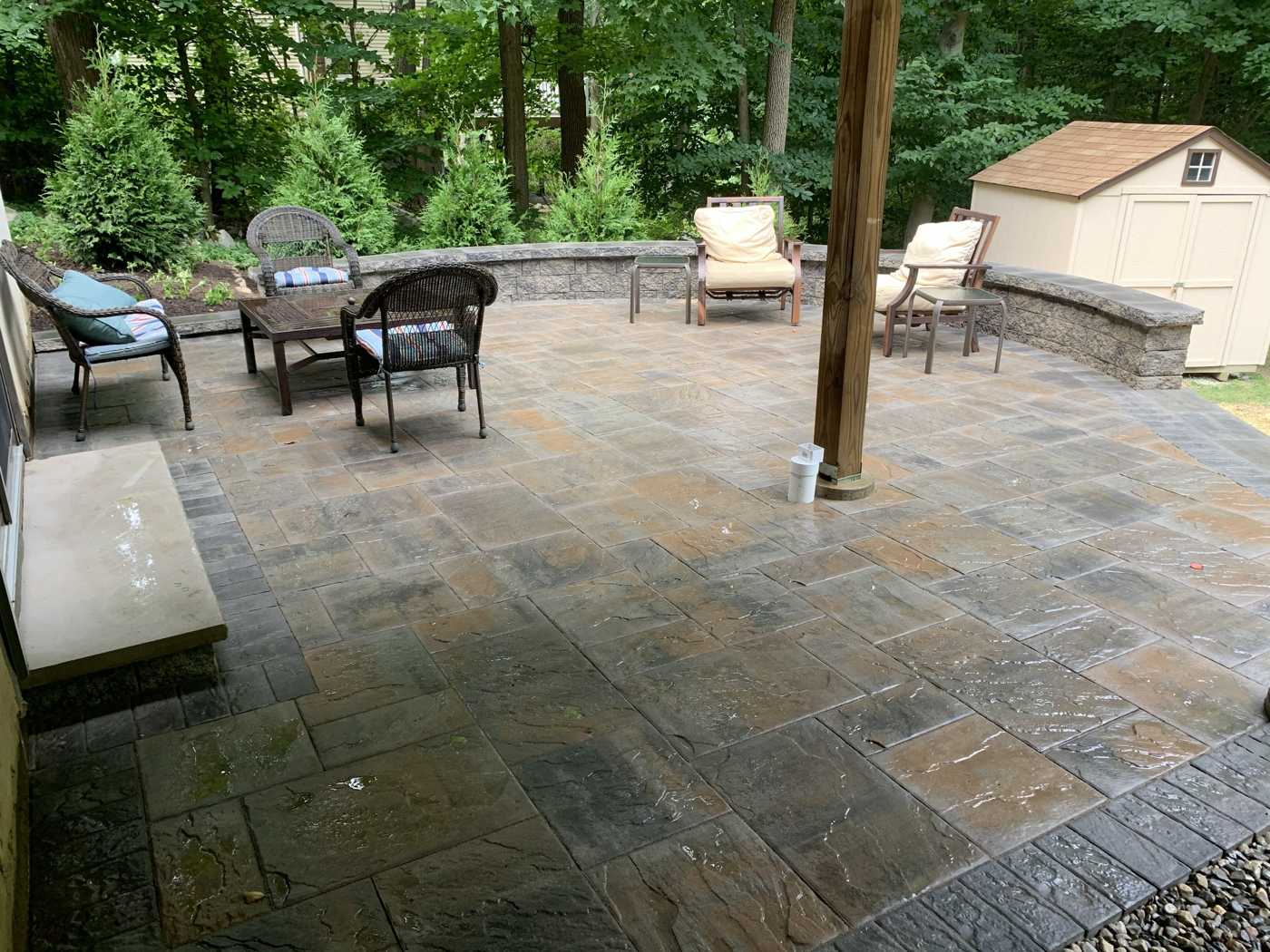 Tiered stone patio with masonry seat wall and textured pavers in Cupsaw Lake, Ringwood NJ