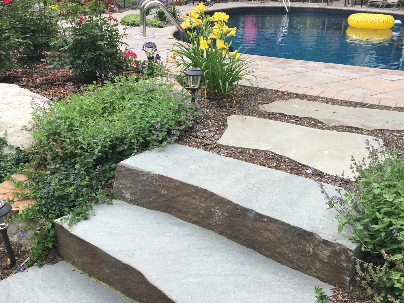 Natural bluestone slab steps and poolside masonry in Ringwood NJ