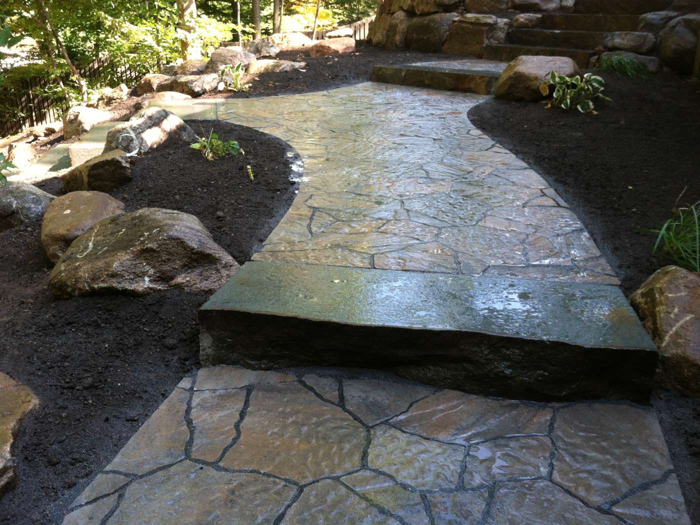 Natural Pennsylvania bluestone walkway with massive stone treads on a sloped yard in Ringwood NJ