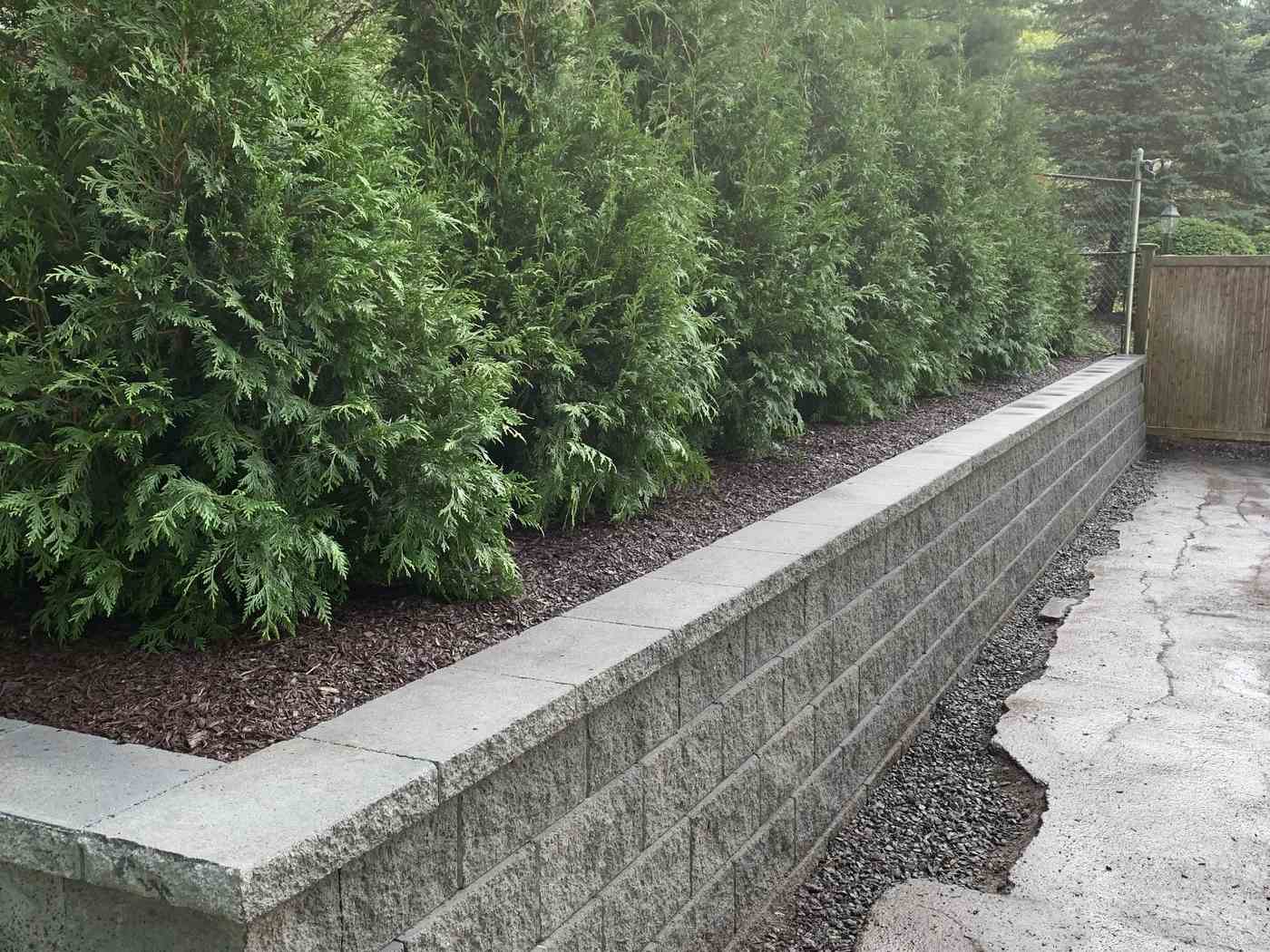 Grey segmental block retaining wall for garden bed and privacy screening in Ringwood NJ