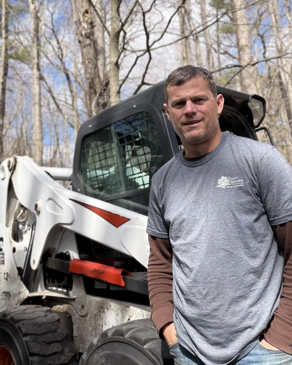 David Miles, owner of Stone and Garden by Design, standing beside a company truck in Ringwood, New Jersey