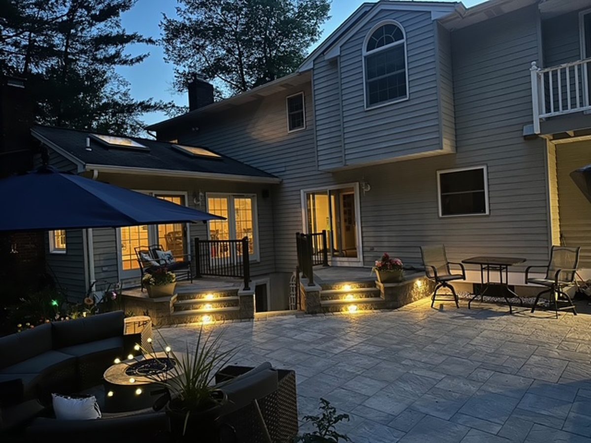 After outdoor living renovation image showing finished patio and lighting upgrade at a Ringwood NJ property